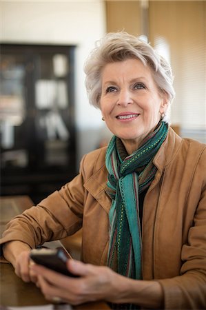 female business woman - Senior woman holding cell phone Stock Photo - Premium Royalty-Free, Code: 614-06814082