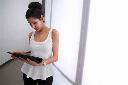 Young woman holding digital tablet, high angle Stock Photo - Premium Royalty-Free, Code: 614-06814150