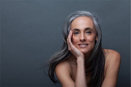 smile women face - Mature woman with hand on chin Stock Photo - Premium Royalty-Free, Code: 614-06814166