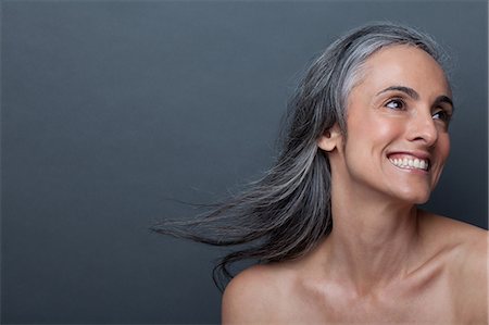 pretty gray hair smiling - Mature woman with windswept hair Stock Photo - Premium Royalty-Free, Code: 614-06814169