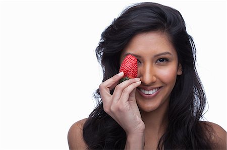 simsearch:614-06814211,k - Young woman covering eye with strawberry Photographie de stock - Premium Libres de Droits, Code: 614-06814193