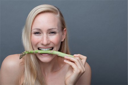 simsearch:614-06814202,k - Young woman biting asparagus Stock Photo - Premium Royalty-Free, Code: 614-06814239