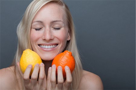 Young woman holding orange and lemon, eyes closed Foto de stock - Sin royalties Premium, Código: 614-06814241