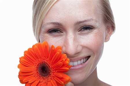 simsearch:614-06814251,k - Young woman with orange flower Foto de stock - Sin royalties Premium, Código: 614-06814257