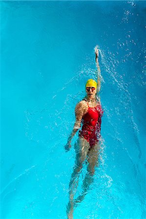 swim cap females - Mature woman doing backstroke in swimming pool Stock Photo - Premium Royalty-Free, Code: 614-06814260