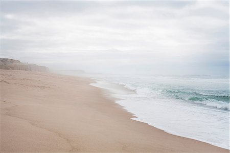 sand and waves - Quiet beach scene with misty horizon Stock Photo - Premium Royalty-Free, Code: 614-06814365