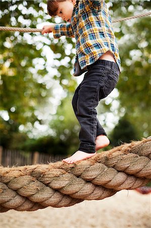 Male toddler crossing rope bridge Stock Photo - Premium Royalty-Free, Code: 614-06814360