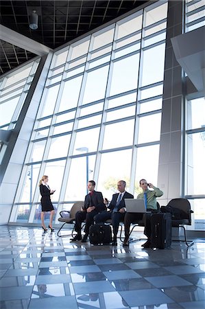 people in airport - Businessman on cell phone using laptop Stock Photo - Premium Royalty-Free, Code: 614-06813227