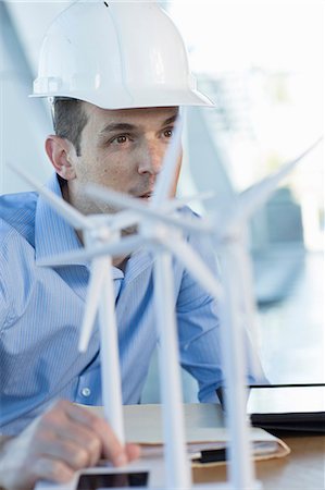 engineering - Engineer with model wind turbines Stock Photo - Premium Royalty-Free, Code: 614-06813256