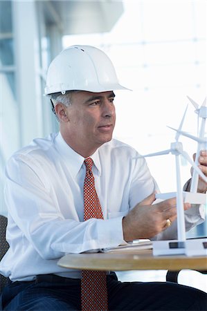 environmental safety business - Engineer with model wind turbines Stock Photo - Premium Royalty-Free, Code: 614-06813259