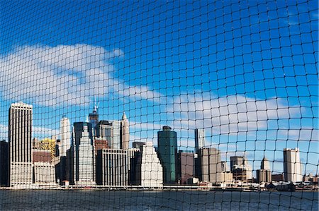 View of Manhattan skyline through netting, New York City, USA Stock Photo - Premium Royalty-Free, Code: 614-06813343