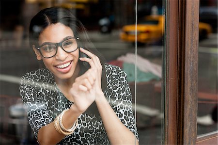 Woman knocking on glass window to get someone's attention Stock Photo - Premium Royalty-Free, Code: 614-06813674