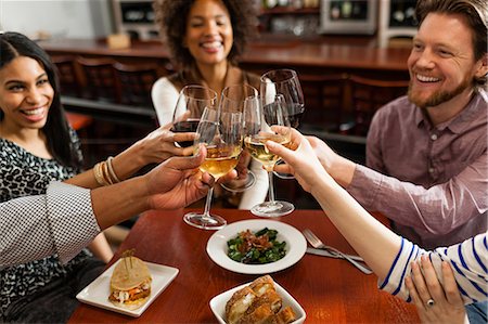 Friends at restaurant toasting Stock Photo - Premium Royalty-Free, Code: 614-06813680