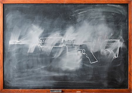 destructive - Partially erased chalk drawing of gun on blackboard Stock Photo - Premium Royalty-Free, Code: 614-06813711
