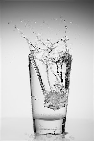 simsearch:614-06813741,k - Ice cube falling into glass of water Stock Photo - Premium Royalty-Free, Code: 614-06813736