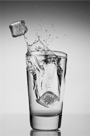 simsearch:649-08119128,k - Ice cubes falling into glass of water Stock Photo - Premium Royalty-Free, Code: 614-06813739