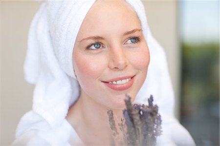 Young woman wearing towel on head with lavender Stock Photo - Premium Royalty-Free, Code: 614-06813805