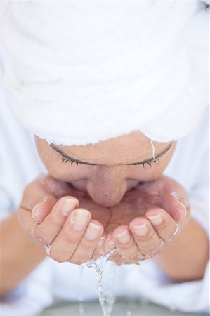 Young woman washing face Stock Photo - Premium Royalty-Free, Code: 614-06813816