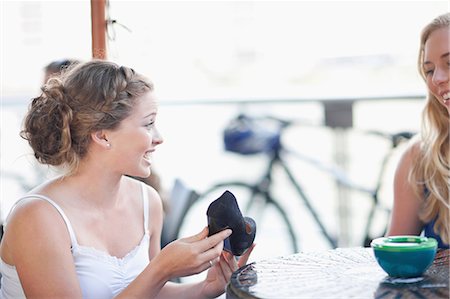 Young woman showing off her new shoe Stock Photo - Premium Royalty-Free, Code: 614-06813888