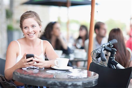 devices - Young woman at cafe Stock Photo - Premium Royalty-Free, Code: 614-06813900