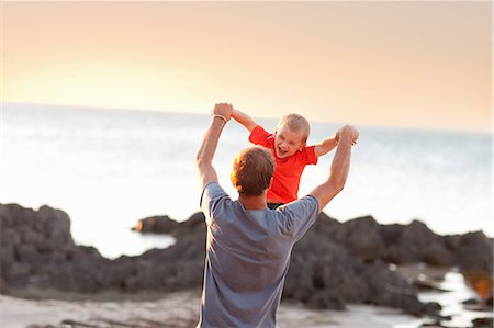 fathers carrying sons on the beach - Father playing with son on beach Stock Photo - Premium Royalty-Free, Code: 614-06813924