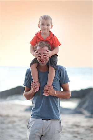 family summer holiday humour - Father carrying son on shoulders Stock Photo - Premium Royalty-Free, Code: 614-06813930