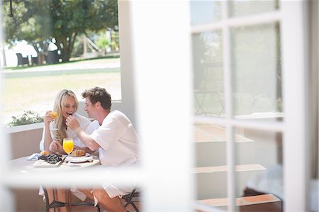 Young couple having breakfast on patio Stock Photo - Premium Royalty-Free, Code: 614-06813958
