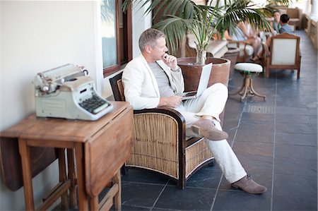Casual businessman using laptop Stock Photo - Premium Royalty-Free, Code: 614-06813970