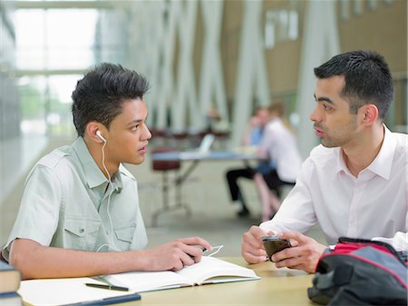 Young man studying with mid adult tutor Stock Photo - Premium Royalty-Free, Code: 614-06895712