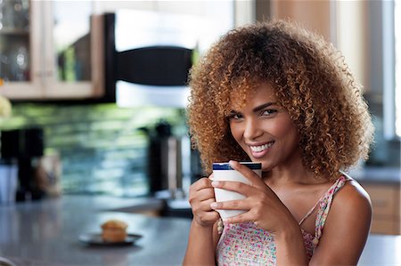 Mid adult woman enjoying coffee in kitchen, portrait Stock Photo - Premium Royalty-Free, Code: 614-06895885