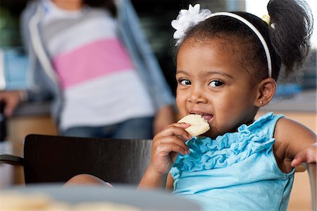 family inside cookies - Young girl eating biscuits, portrait Stock Photo - Premium Royalty-Free, Code: 614-06895952