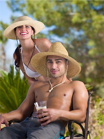 Young couple wearing sun hats and relaxing on vacation, portrait Stock Photo - Premium Royalty-Free, Code: 614-06896006