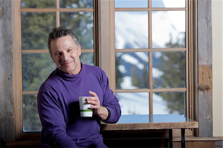 purple people - Mature man holding hot drink indoors, smiling Stock Photo - Premium Royalty-Free, Code: 614-06896037