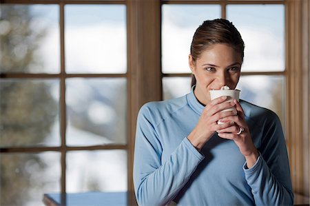 drinking hot drink outside - Young woman enjoying hot drink indoors Stock Photo - Premium Royalty-Free, Code: 614-06896039