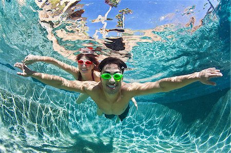 relax hispanic man - YYoung couple swimming underwater in pool Stock Photo - Premium Royalty-Free, Code: 614-06896033