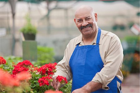 pictures of men with bald head and moustache - Mature man holding flowers in garden centre, smiling Foto de stock - Sin royalties Premium, Código: 614-06896204