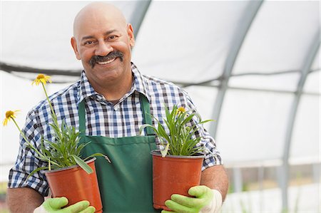 simsearch:614-06896281,k - Mature man holding plant pots in garden centre, portrait Stock Photo - Premium Royalty-Free, Code: 614-06896298