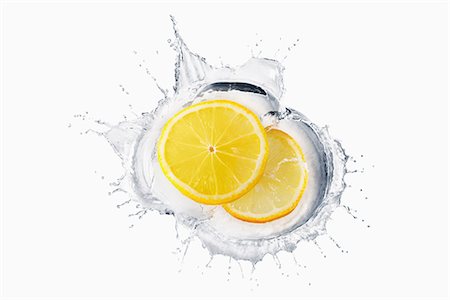 slices fruit - Two slices of lemon splashing in liquid Stock Photo - Premium Royalty-Free, Code: 614-06896423