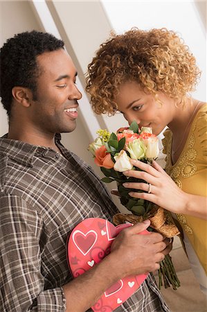 smell chocolate - Man giving woman flowers and chocolates on valentines day Stock Photo - Premium Royalty-Free, Code: 614-06896476