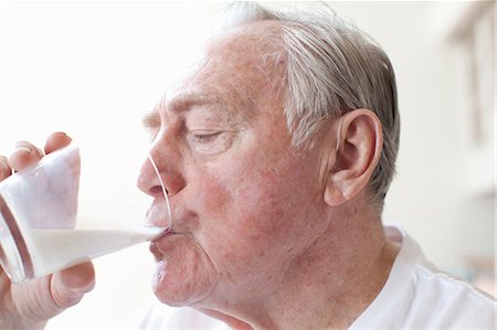 Senior man drinking glass of milk Fotografie stock - Premium Royalty-Free, Codice: 614-06896535