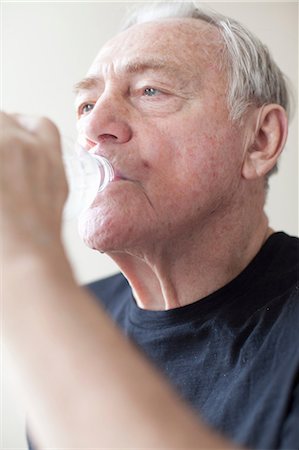 Senior man drinking mineral water Stock Photo - Premium Royalty-Free, Code: 614-06896536