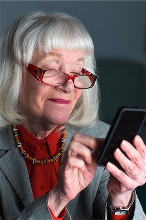 smartphone app - Senior woman using smartphone Stock Photo - Premium Royalty-Free, Code: 614-06896547