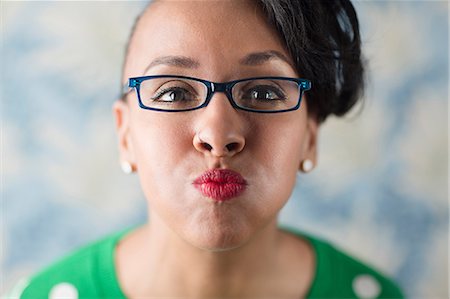 portraits kitschy - Close up portrait of woman puckering her lips Stock Photo - Premium Royalty-Free, Code: 614-06896553