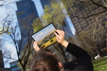 sunny city day - Woman in city park looking at digital tablet screen Stock Photo - Premium Royalty-Free, Code: 614-06896571