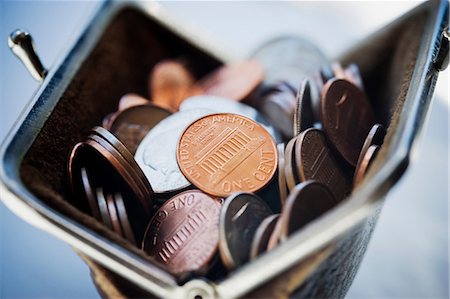 Purse filled with coins Stock Photo - Premium Royalty-Free, Code: 614-06896640