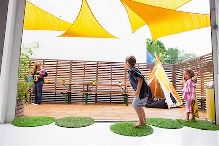 Children playing on patio Stock Photo - Premium Royalty-Free, Code: 614-06896706