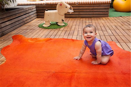 plancher de bois dur - Baby girl crawling on orange rug, portrait Photographie de stock - Premium Libres de Droits, Code: 614-06896707