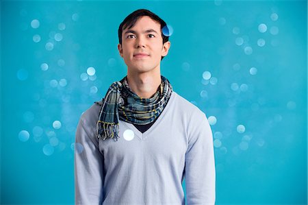 Portrait of young man wearing blue jumper and scarf Stock Photo - Premium Royalty-Free, Code: 614-06896859