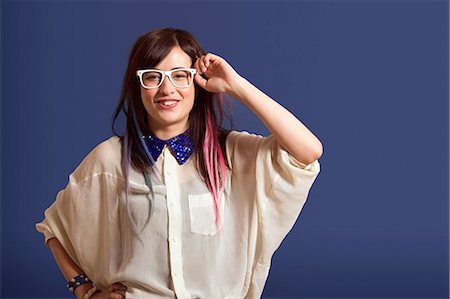 Portrait of young woman with dyed hair wearing glasses Stock Photo - Premium Royalty-Free, Code: 614-06896865