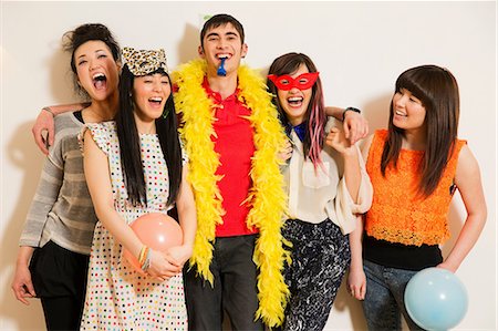 people in a party laughing - Friends at a party with balloons, studio shot Stock Photo - Premium Royalty-Free, Code: 614-06896887